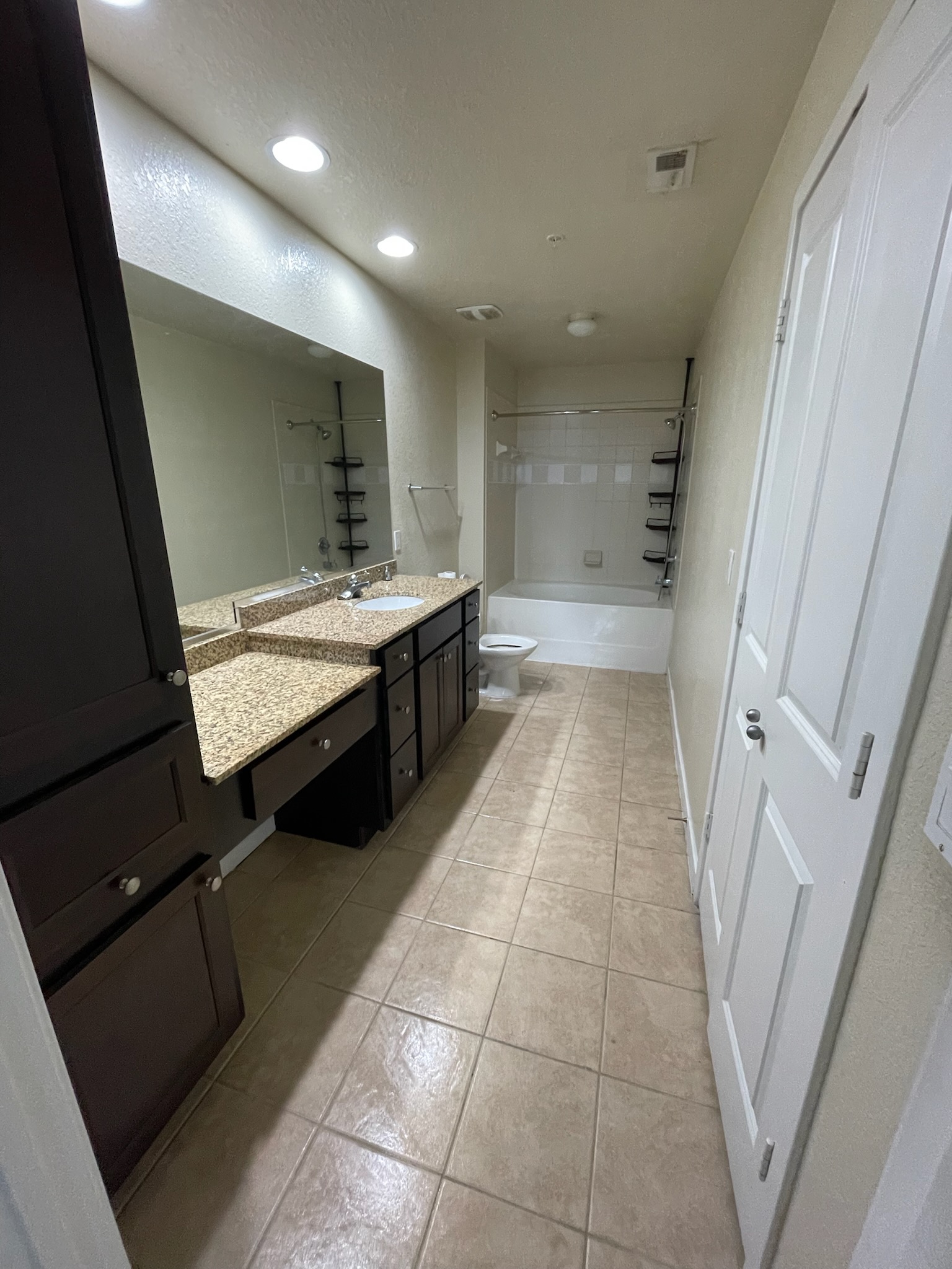 Cleaner detailing baseboards and kitchen surfaces during a deep cleaning in a Palm Beach Gardens home